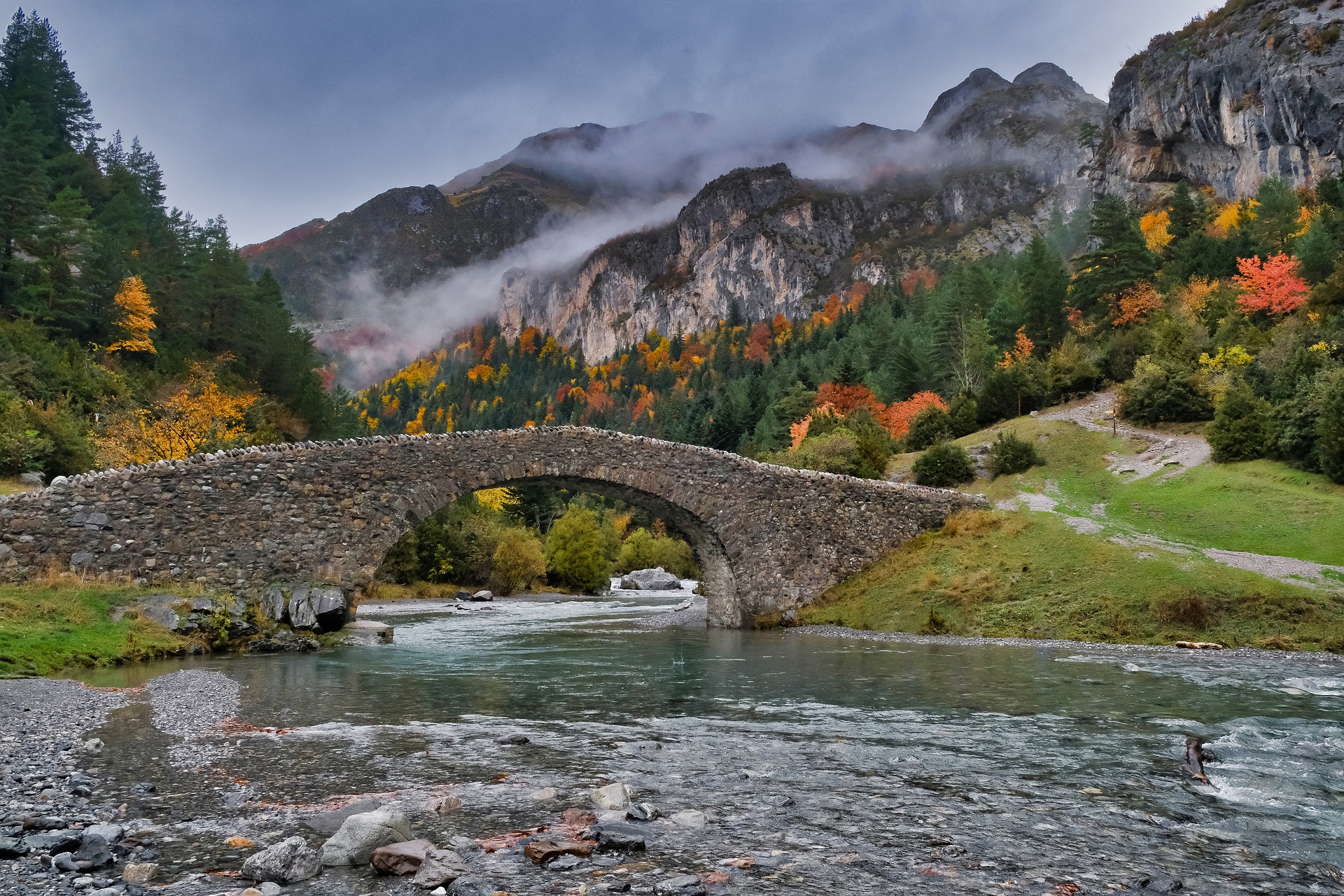 Stone bridge and autumn forest in the Ordesa Valley